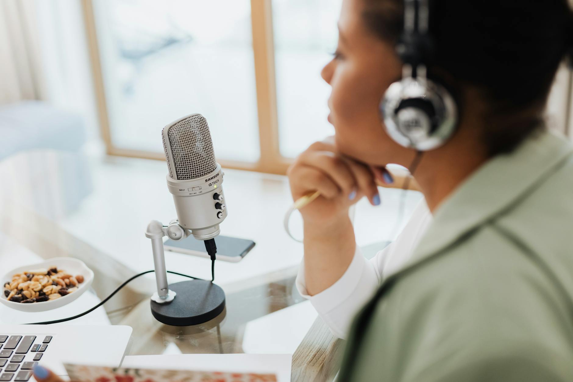 woman using headphones and microphone with laptop